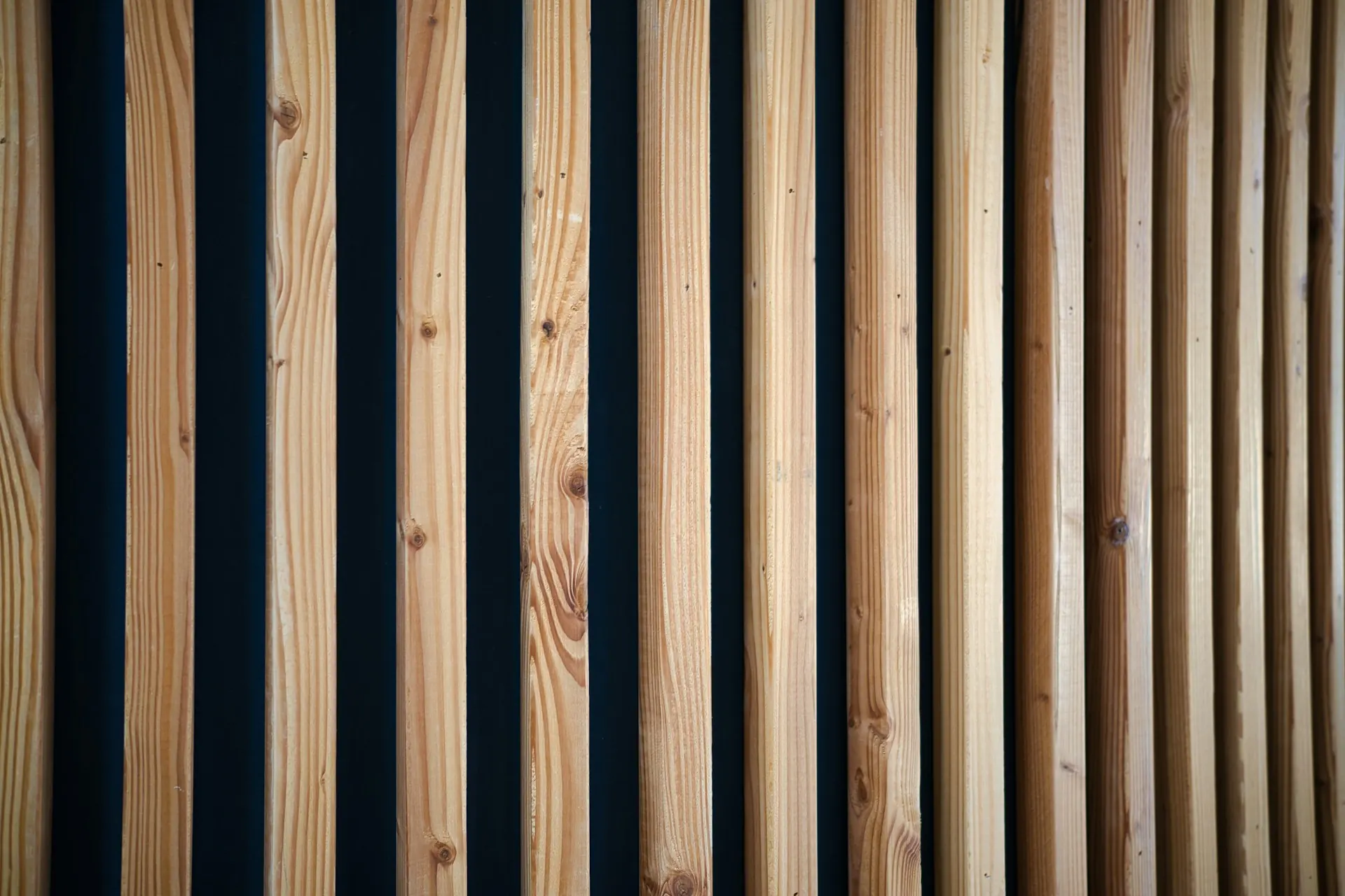 Close view of vertical wooden slats with narrow dark gaps between them.
